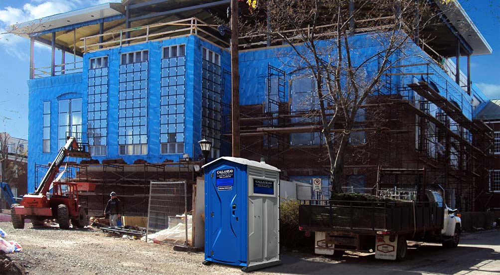 The Blue And White Construction Toilet Near Building Site
