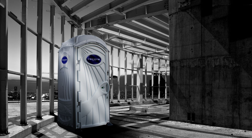 A White Toilet Portable Restroom Near Construction Site