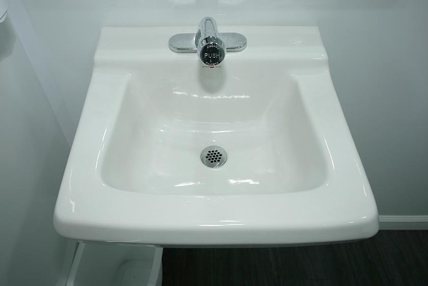 LARGE PORCELAIN SINK INSIDE THE WHEELCHAIR ACCESSIBLE RESTROOM