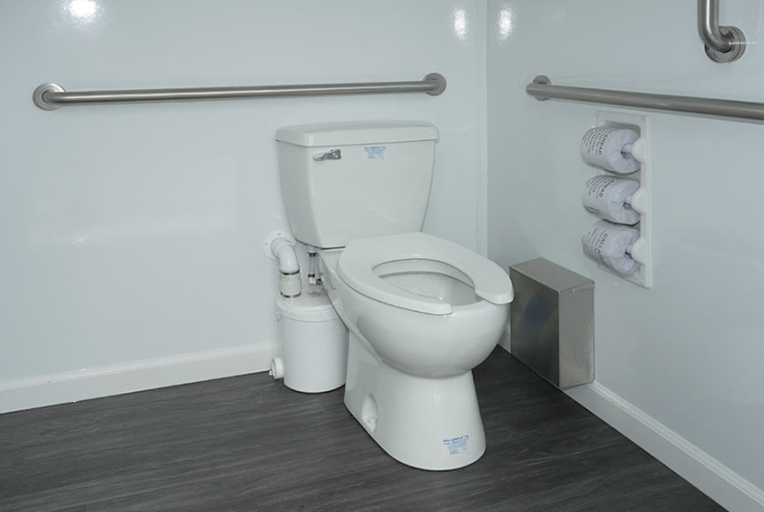 FULL SIZED ADA COMPLIANT PORCELAIN FLUSHING TOILET WITH MACERATOR