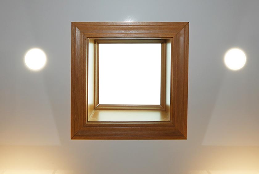 SKYLIGHT WITH LOW VOLTAGE LIGHTING IN THE CEILINGS AND OVER THE VANITY MIRRO