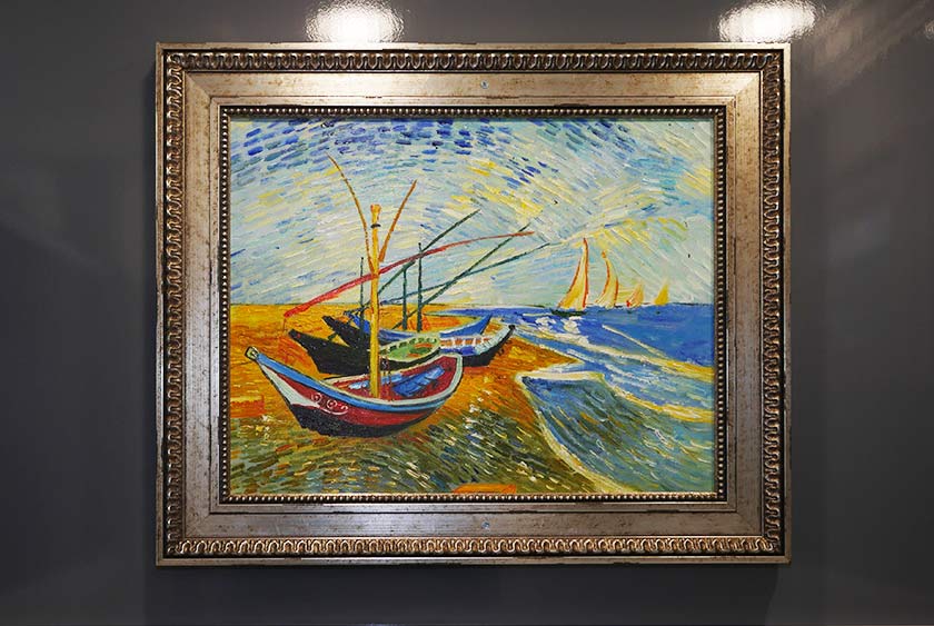 GOLD TRIMMED FRAMED ARTWORK INSIDE TOILET STALLS AND COMMON AREAS