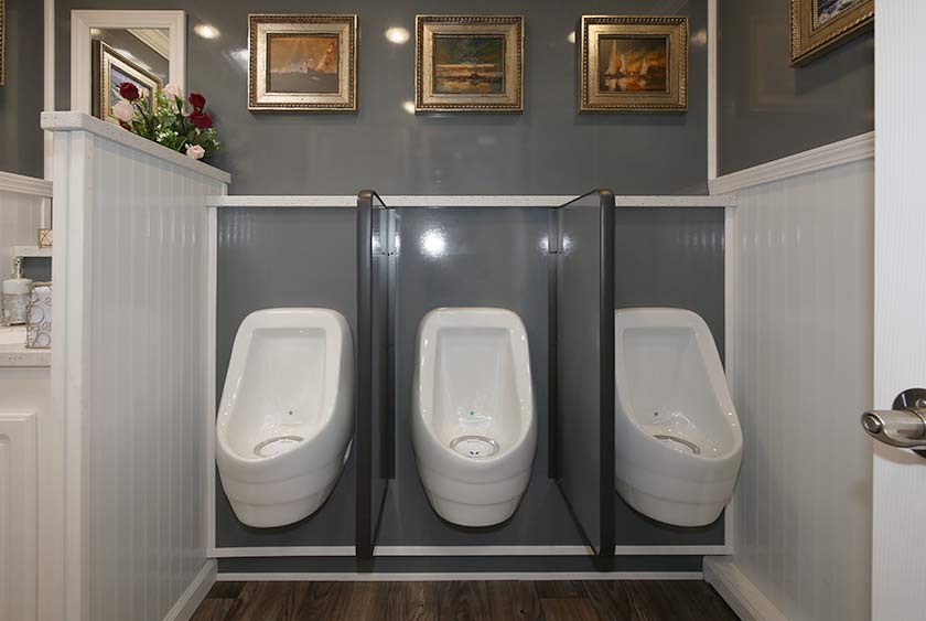 THREE PORCELAIN URINALS ON THE MEN'S SIDE