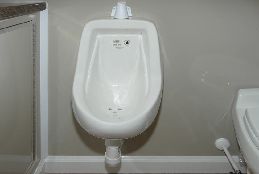 PORCELAIN URINAL IN MEN'S RESTROOM