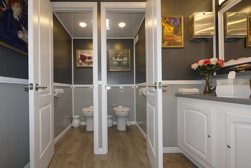 PRIVATE AND VERY SPACIOUS BATHROOM STALLS WITH PEDAL FLUSH PORCELAIN TOILET BOWLS