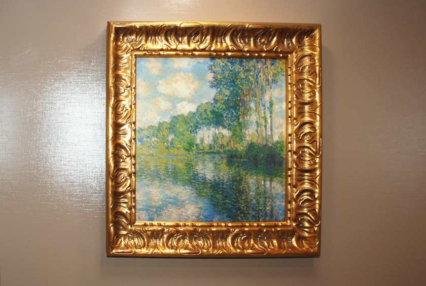 GOLD LEAF WOOD-FRAMED ARTWORK IN TOILET STALLS AND VANITY AREAS