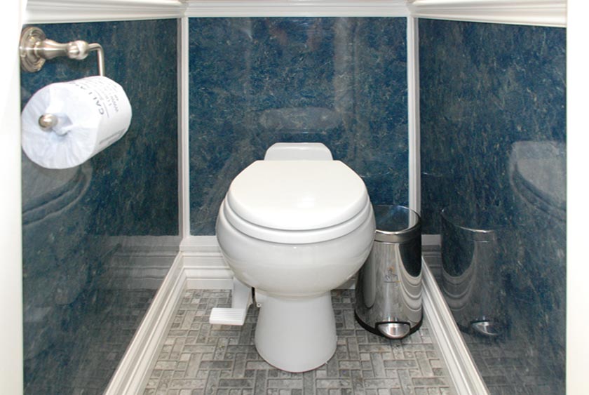 PEDAL-FLUSH PORCELAIN TOILET WITH TRASH CAN IN EACH STALL