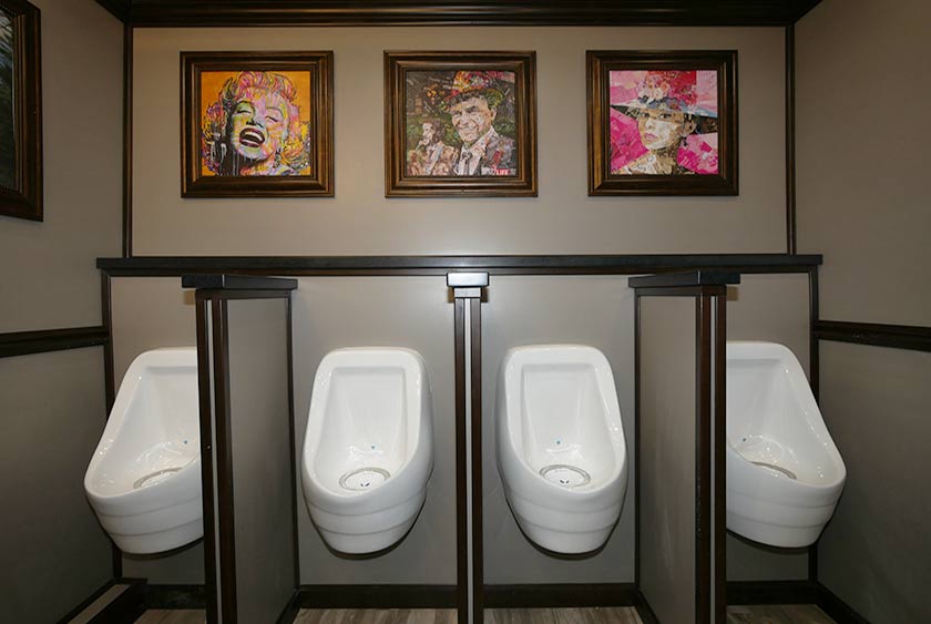 FOUR ODORLESS PORCELAIN URINALS IN MEN'S ROOM