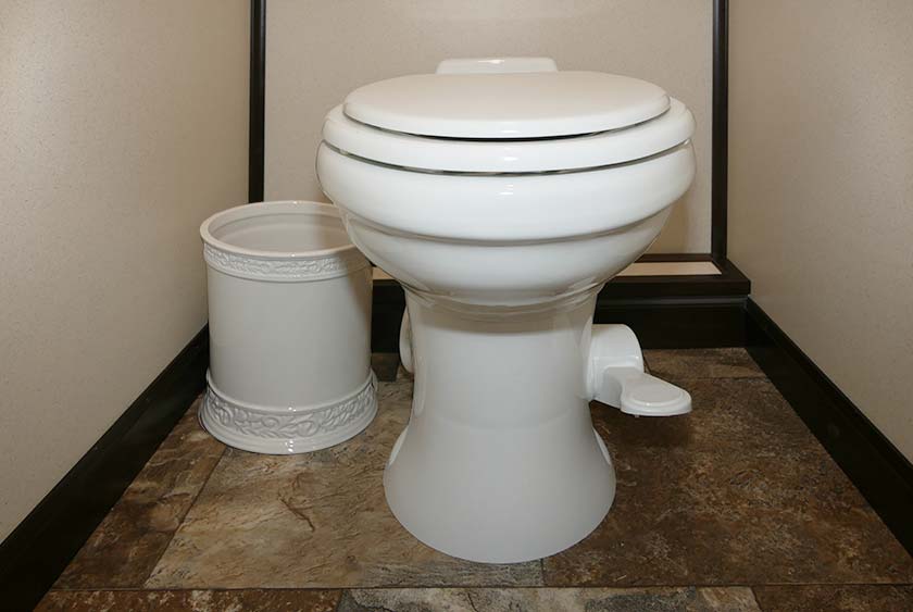 PORCELAIN WASTE BASKETS INSIDE EACH TOILET STALL