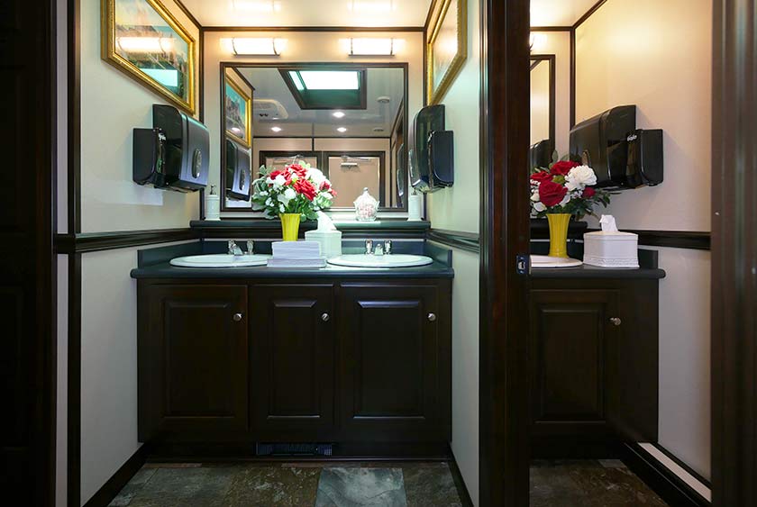 WOMEN'S SIDE HAS A DOUBLE VANITY, PLUS A SINGLE VANITY INSIDE A SEPARATE STALL