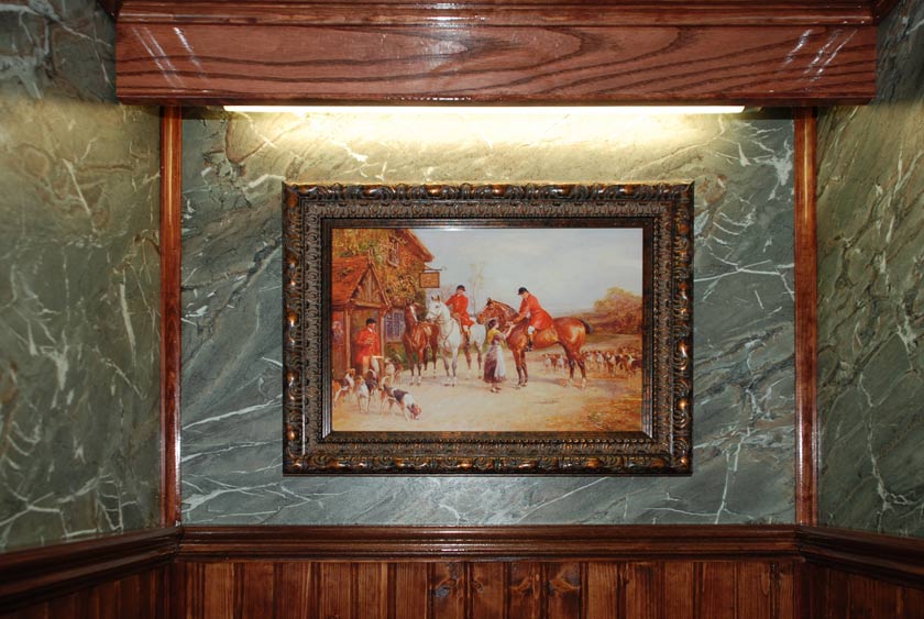 FRAMED ARTWORK WITHIN EACH STALL OF THIS LUXURY RESTROOM TRAILER