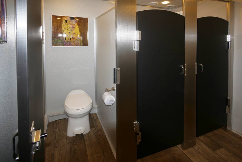 SOLID DOORS ENCLOSE PRIVATE STALLS, EACH WITH THEIR OWN SOPHISTICATED ARTWORK