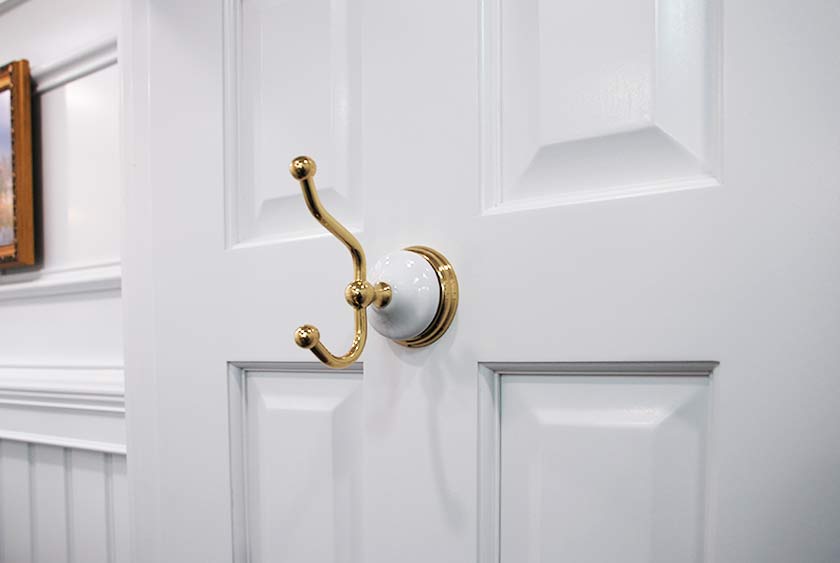 POLISHED BRASS AND PORCELAIN COAT AND HAT HOOK
