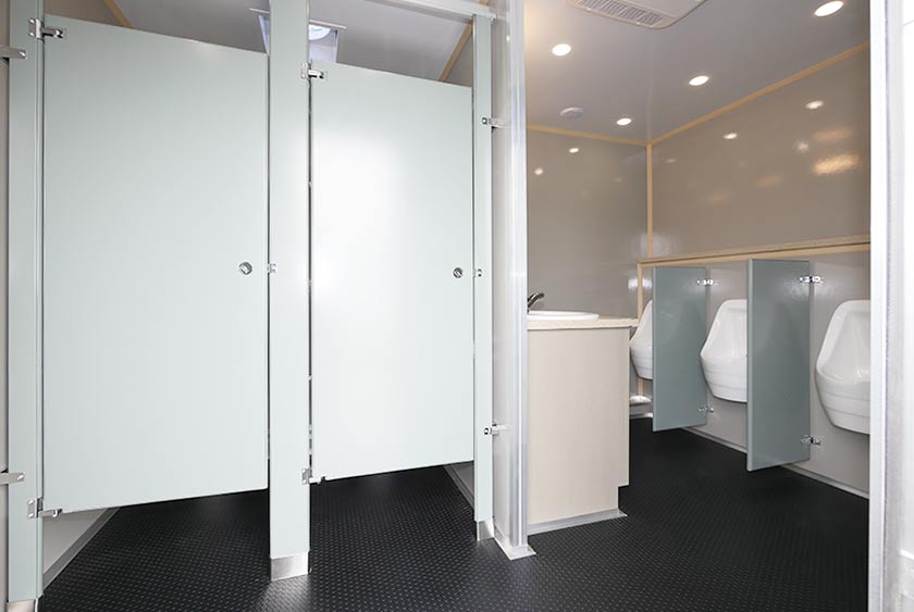 MEN'S BATHROOM INCLUDES 2 TOILET STALLS, 4 URINALS AND A DOUBLE SINK VANITY