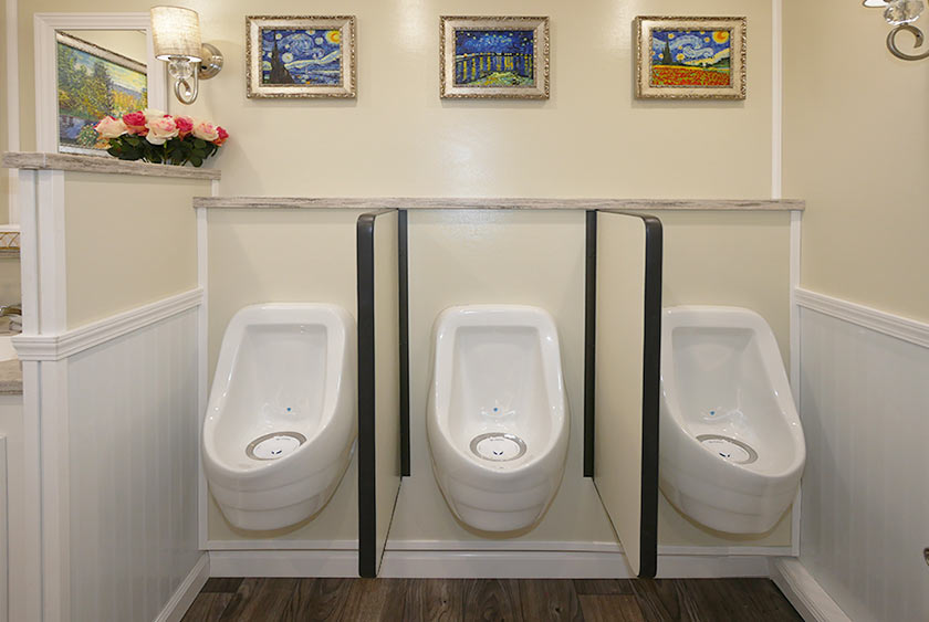 THREE PORCELAIN URINALS ON THE MEN'S SIDE
