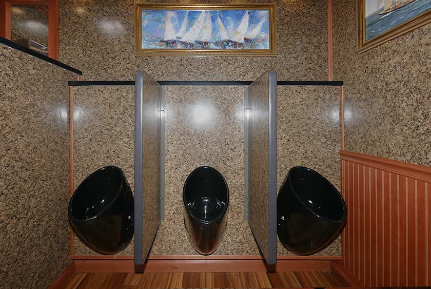THREE BLACK SLOAN ODORLESS URINALS WITH PRIVACY DIVIDERS