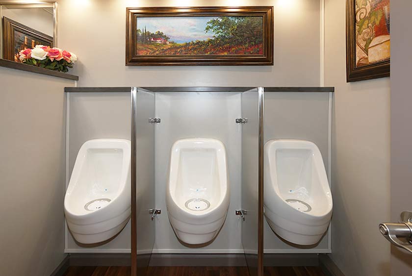 THREE ODORLESS, PORCELAIN URINALS ON THE MEN'S SIDE